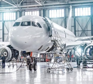 Passenger aircraft on maintenance of engine and fuselage repair in airport hangar